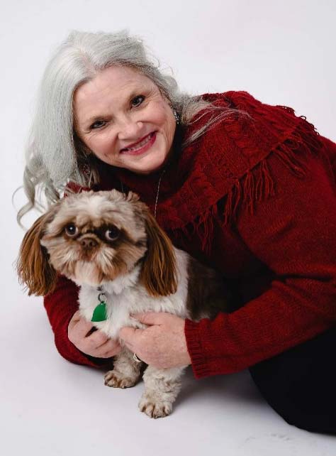 Ann Elliot smiling with her dog
